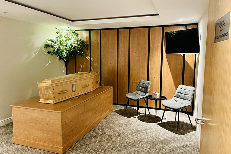 Chairs and a coffin inside Woodlands Rest in Love's Independent Funeral Directors