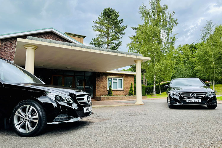 Stafford Crematorium entrance with two Love's Funeral Directors cars outside